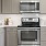 a kitchen with grey cabinets and wood floors