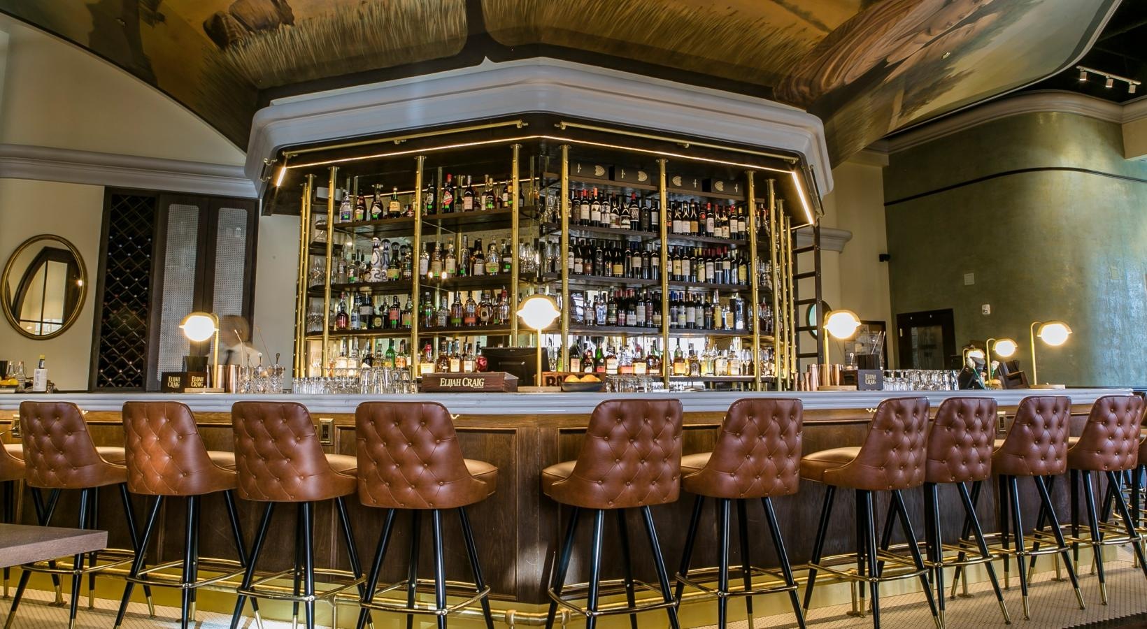 The essence of exceptional living a bar with chairs and tables