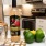 a bottle of wine next to fruit and a glass with a straw