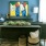 a room with a table and a painting on the wall