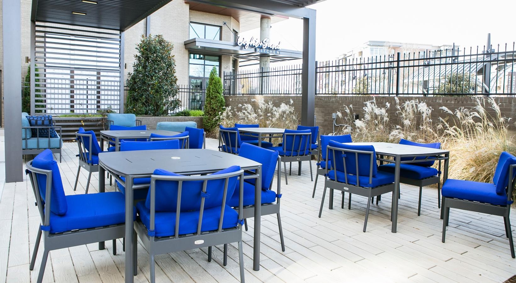 Settle into comfort at Bradham at New Bern a group of tables and chairs outside