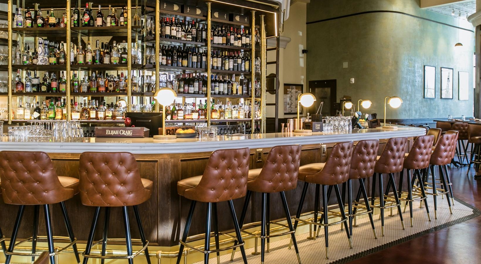 Bustling community with plenty of dining choices a bar with a bar and chairs